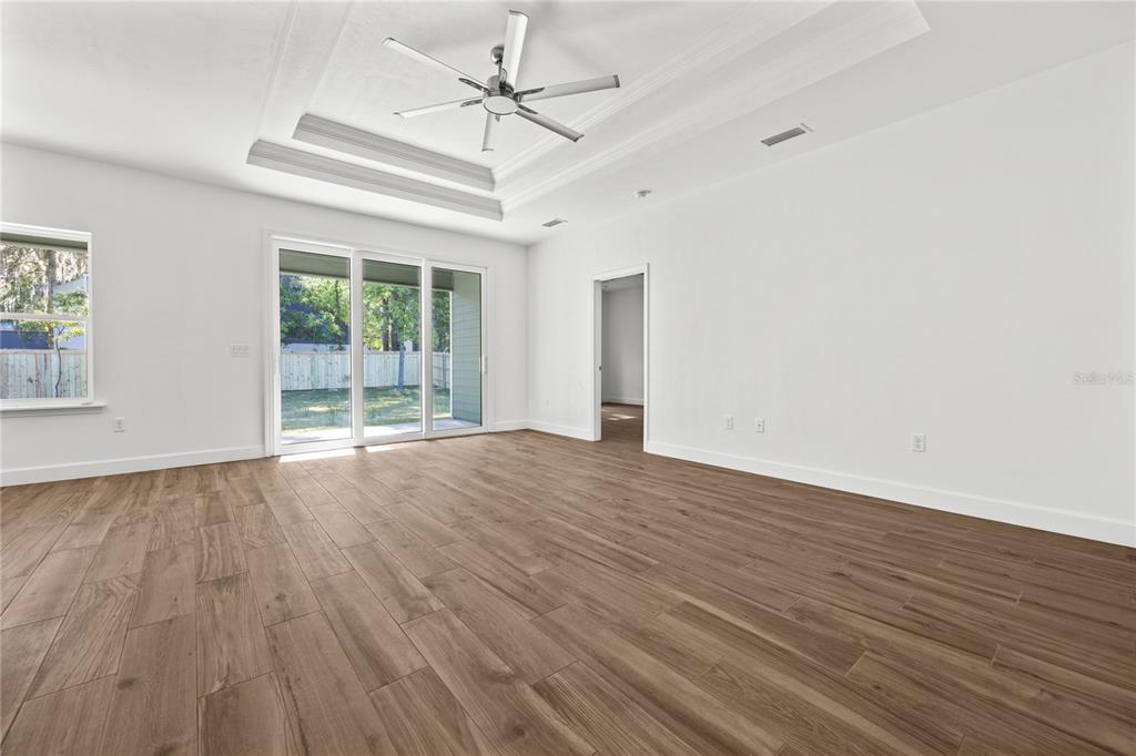 1086 Southwest 67th Drive Gainesville, FL 32607 - Photo 17 of 37 wooden floor in an empty room with a window