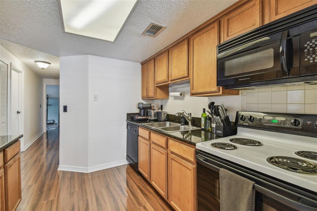 134 Sycamore Lane, Unit H Oldsmar, FL 34677 - Photo 12 of 44 a kitchen with a stove and a microwave