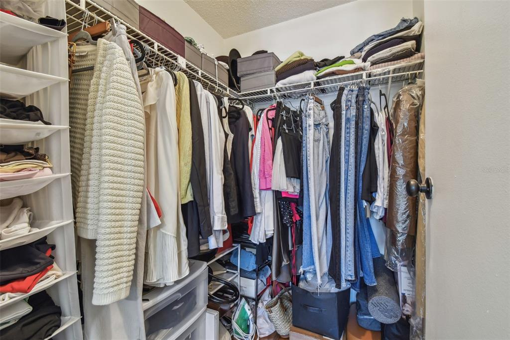 134 Sycamore Lane, Unit H Oldsmar, FL 34677 - Photo 21 of 44 a view of walk in closet with clothes and shoes