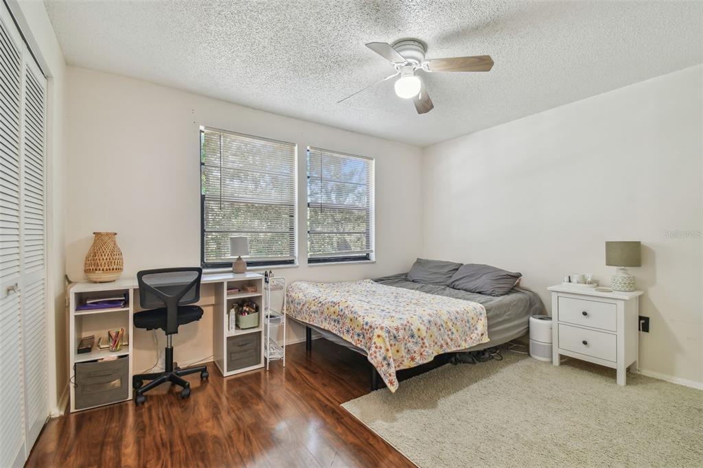134 Sycamore Lane, Unit H Oldsmar, FL 34677 - Photo 29 of 44 a bedroom with a bed and a table