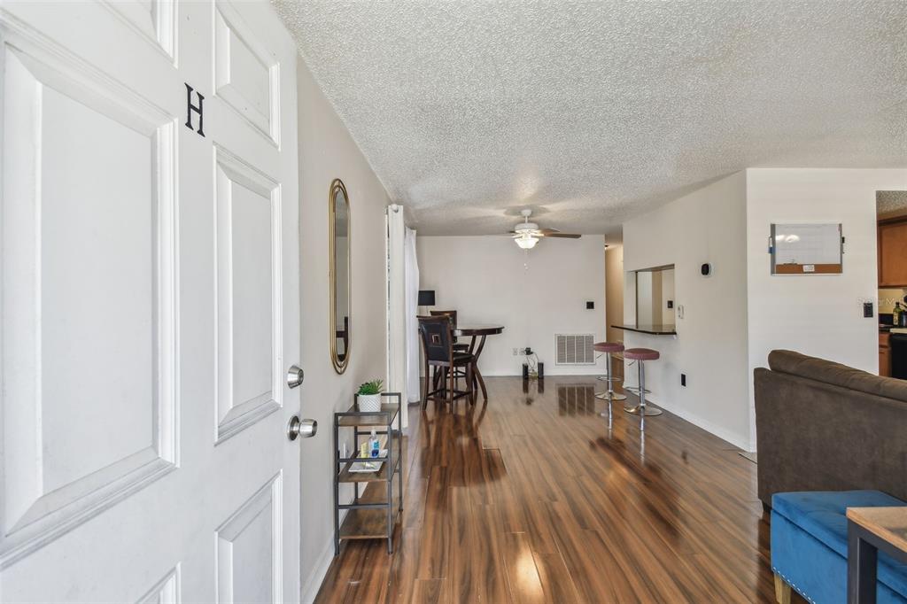 134 Sycamore Lane, Unit H Oldsmar, FL 34677 - Photo 3 of 44 a living room with furniture and wooden floor