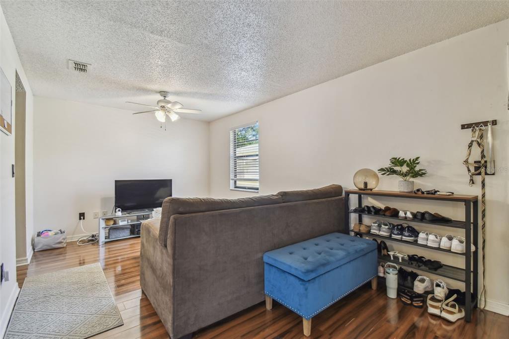 134 Sycamore Lane, Unit H Oldsmar, FL 34677 - Photo 6 of 44 a living room with furniture and wooden floor