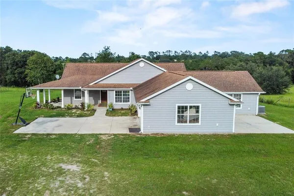 a aerial view of a house with a yard and plants