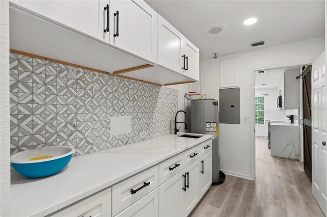 a kitchen with a sink and a refrigerator