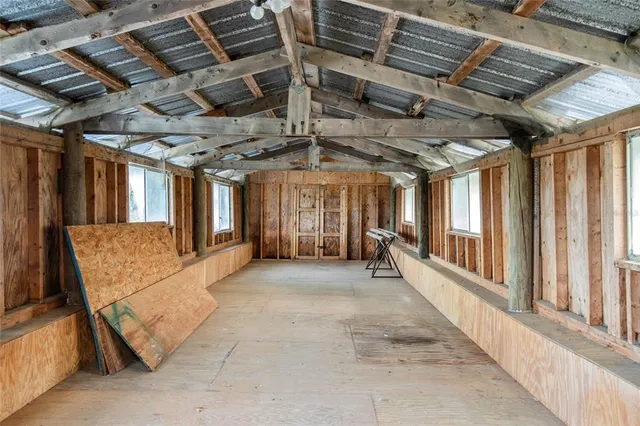 a backyard of a house with swing and outdoor seating