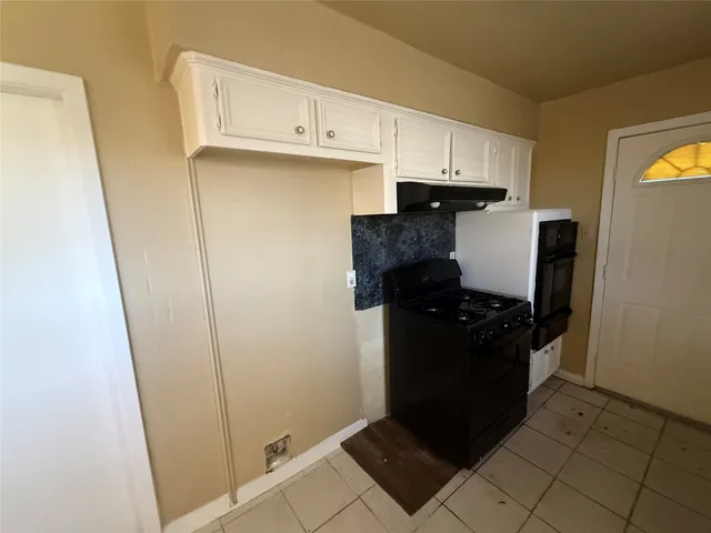 a kitchen with a sink and a refrigerator