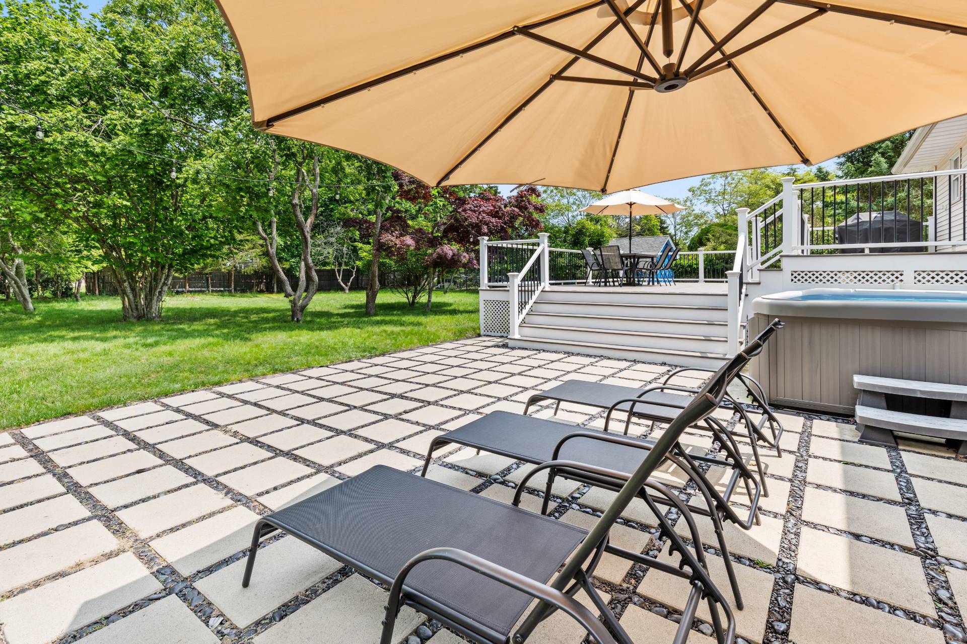 43 Shinnecock Road Hampton Bays, NY 11946 - Photo 3 of 17 a view of a patio with table and chairs under an umbrella