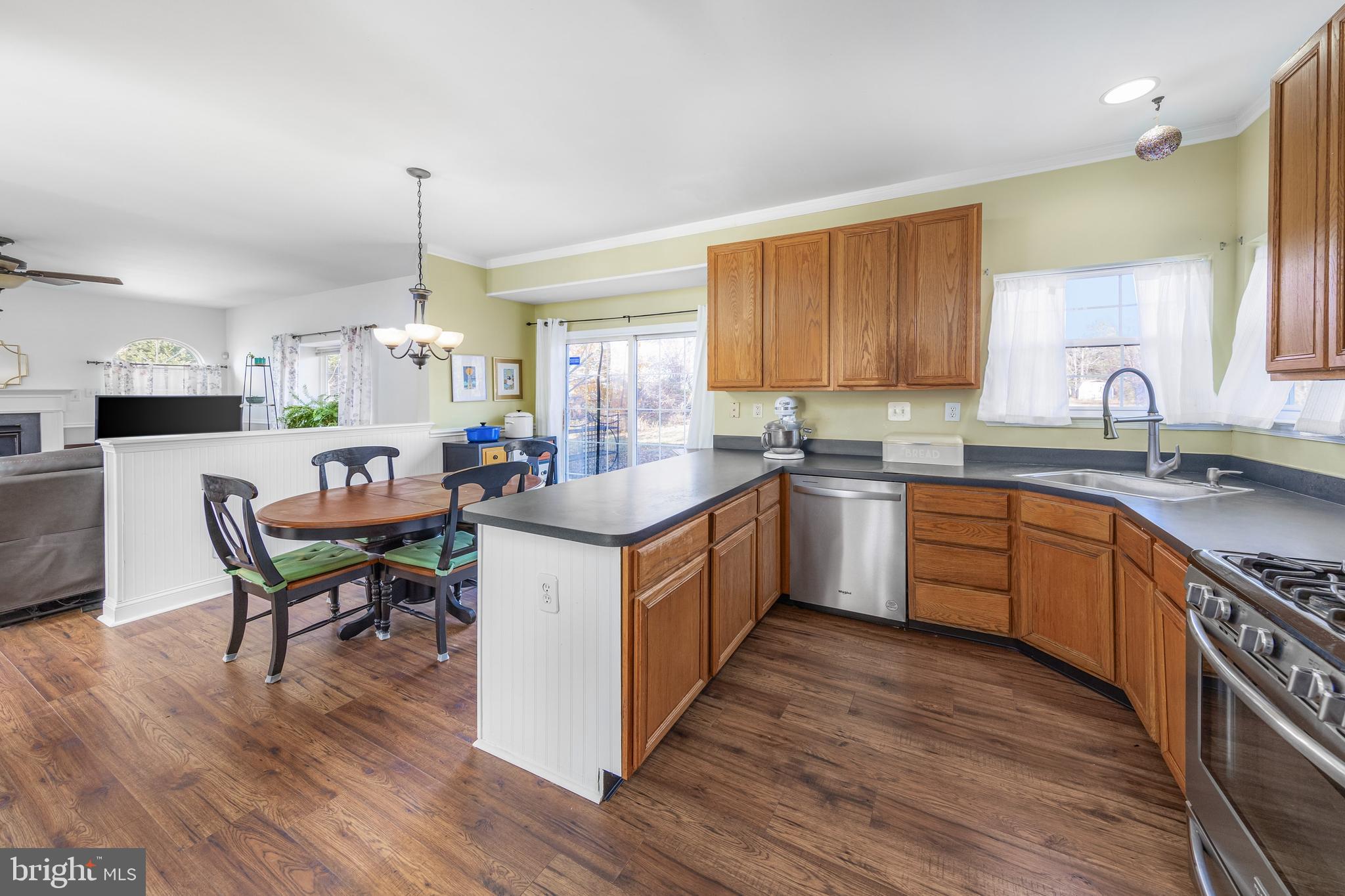 29 Peach Ridge Drive Mullica Hill, NJ 08062 - Photo 12 of 31 a kitchen with a sink cabinets wooden floor and view living room