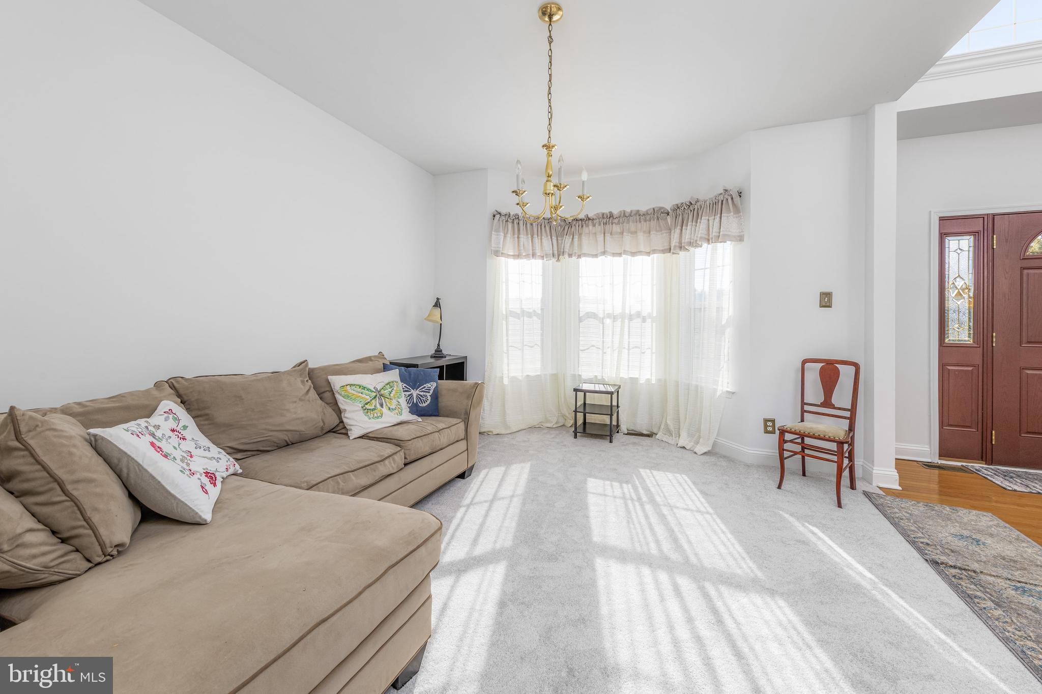 29 Peach Ridge Drive Mullica Hill, NJ 08062 - Photo 8 of 31 a living room with furniture and a chandelier