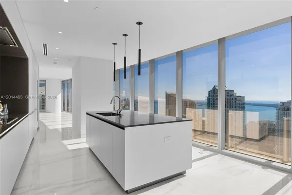 a kitchen with stainless steel appliances kitchen island granite countertop a sink and cabinets