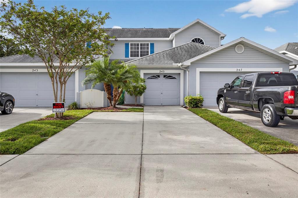 a front view of a house with a yard and garage