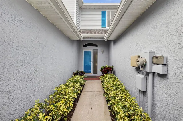 a hallway with beautiful frames and flower vase