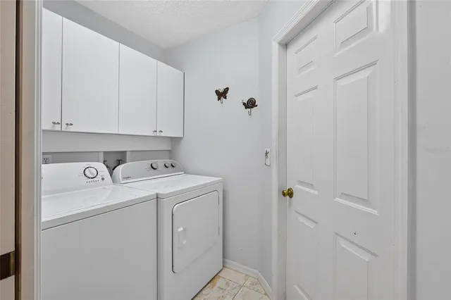a view of storage and utility room with washer and dryer