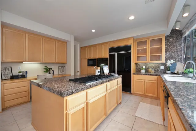 a front view of a house with a yard and potted plants