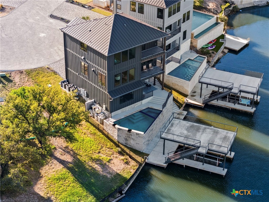 175 Pointview Drive Marble Falls, TX 78654 - Photo 2 of 34 an aerial view of a house with a garden and lake view