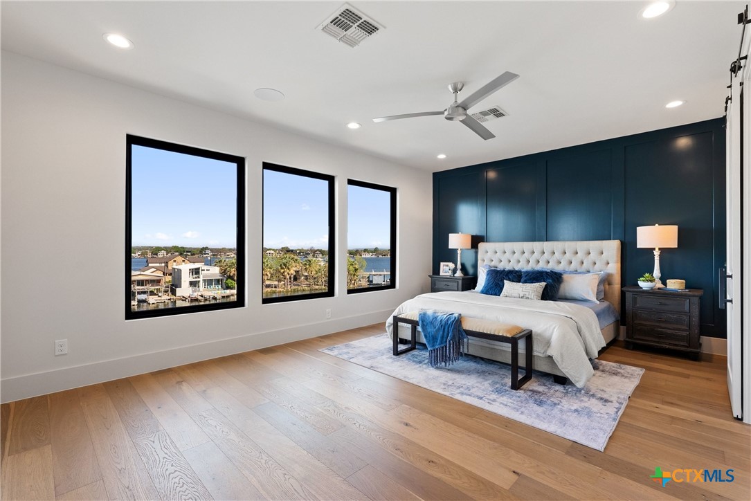 175 Pointview Drive Marble Falls, TX 78654 - Photo 22 of 34 a spacious bedroom with a large bed and a large window