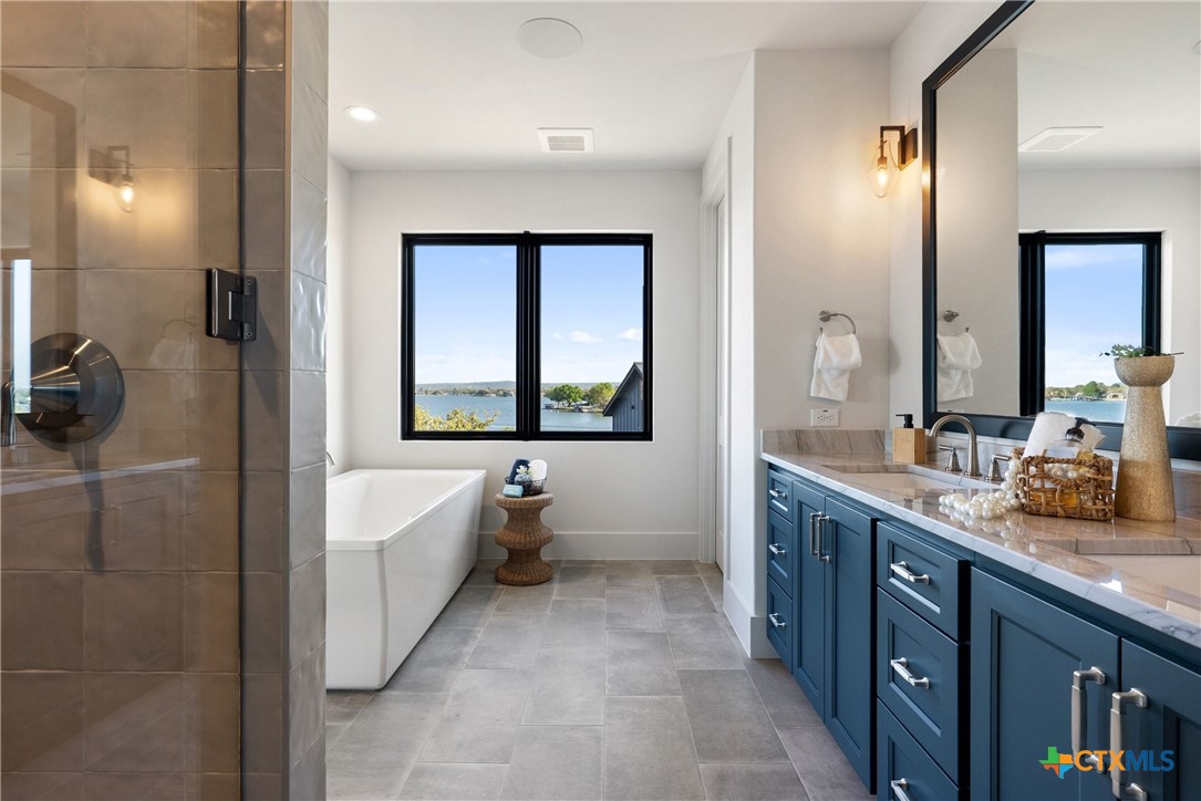 175 Pointview Drive Marble Falls, TX 78654 - Photo 24 of 34 a spacious bathroom with a bathtub sink and mirror