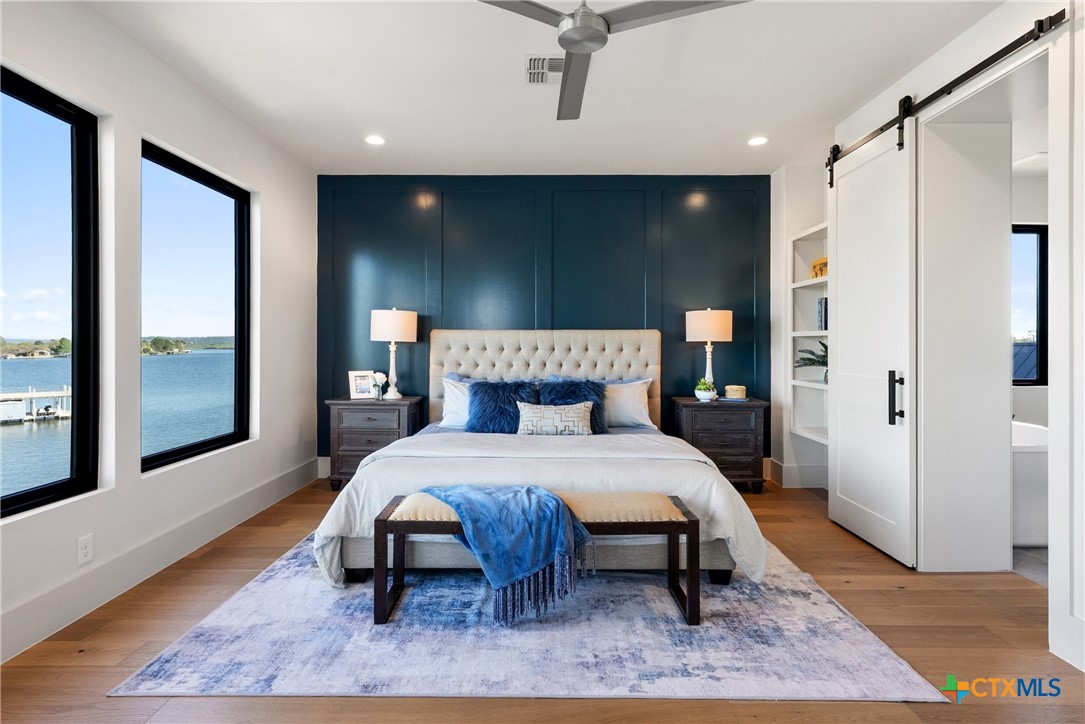 175 Pointview Drive Marble Falls, TX 78654 - Photo 26 of 34 a bed sitting in a spacious bedroom next to a window