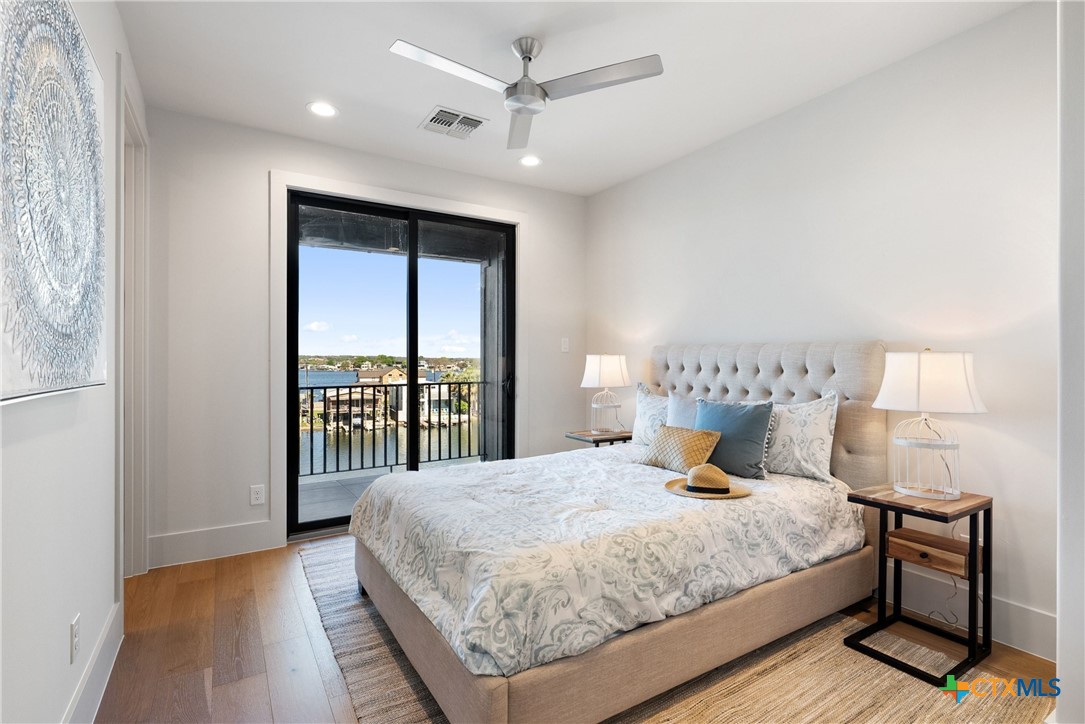 175 Pointview Drive Marble Falls, TX 78654 - Photo 27 of 34 a bedroom with a large bed and a large window