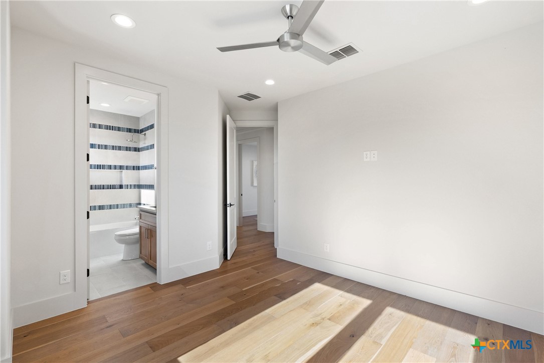 175 Pointview Drive Marble Falls, TX 78654 - Photo 30 of 34 a view of empty room with wooden floor and fan