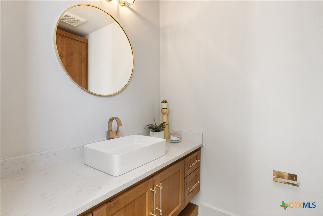 175 Pointview Drive Marble Falls, TX 78654 - Photo 32 of 34 a bathroom with a sink and a mirror