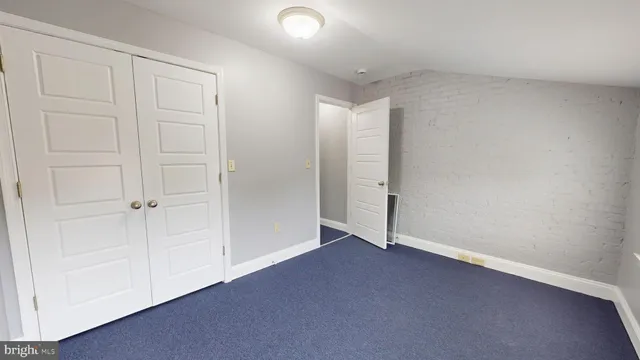 an empty room with closet area