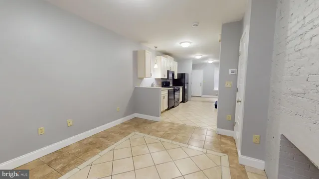 a view of a kitchen with a sink and a refrigerator