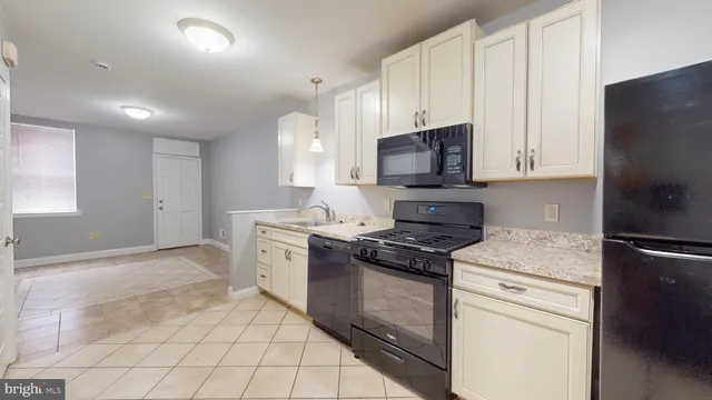 a kitchen with a stove microwave and sink