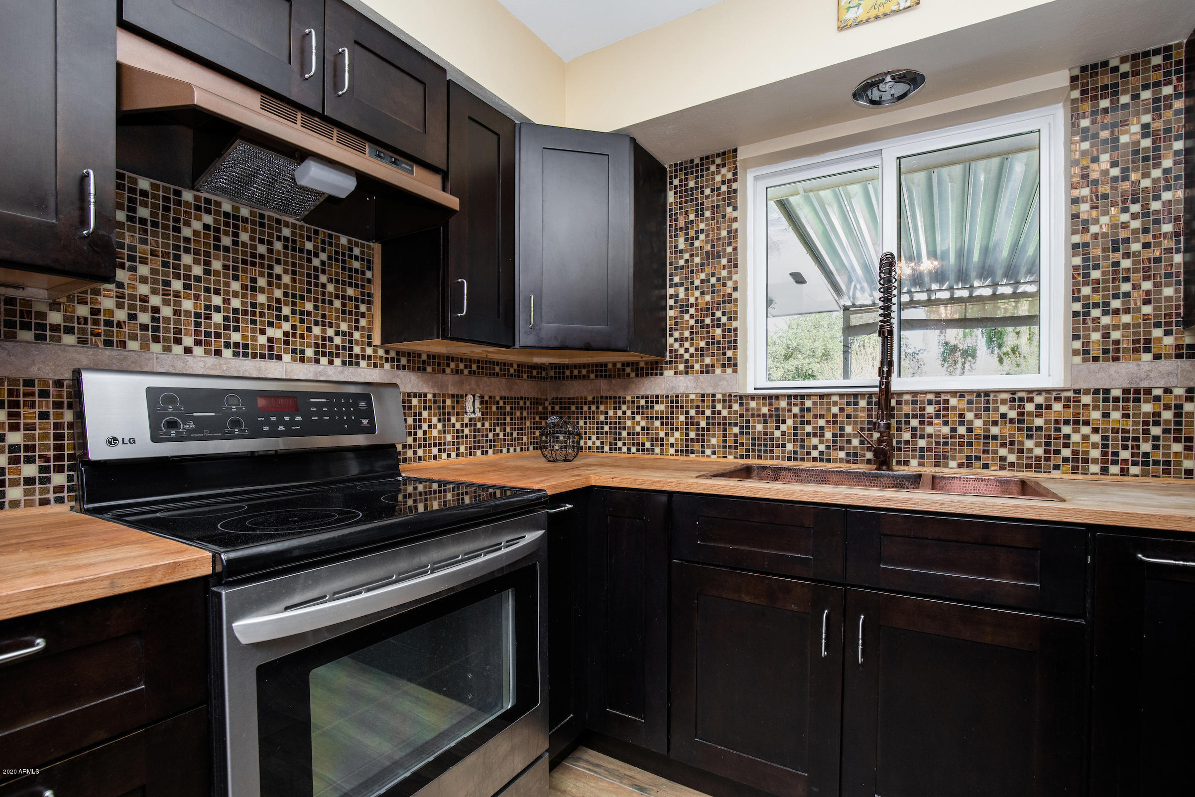 5320 East Decatur Street Mesa, AZ 85205 - Photo 14 of 34 a kitchen with a sink stove and cabinets