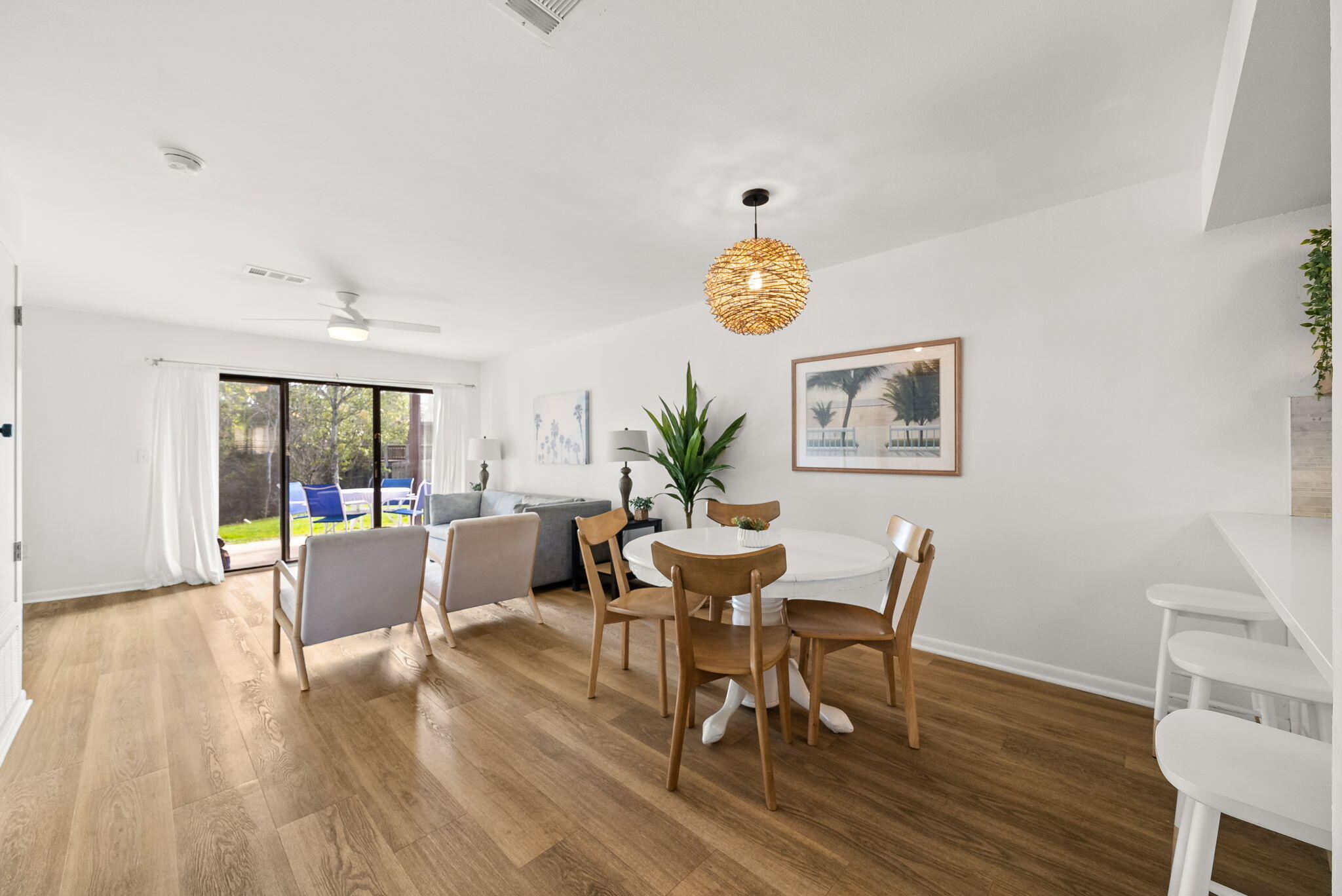 17620 Front Beach Road, Unit J2 Panama City Beach, FL 32413 - Photo 12 of 30 a view of a dining room with furniture and wooden floor
