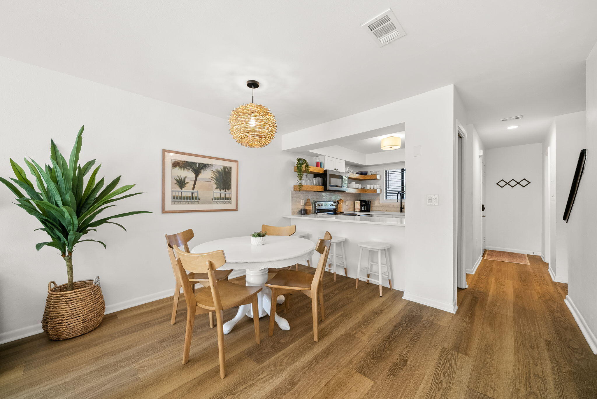 17620 Front Beach Road, Unit J2 Panama City Beach, FL 32413 - Photo 13 of 30 a view of a dining room with furniture and wooden floor