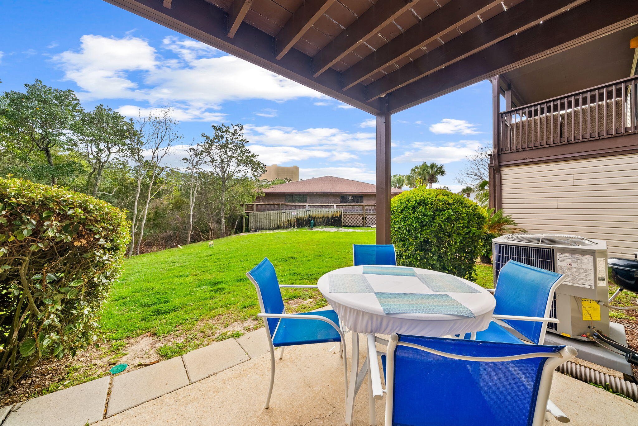 17620 Front Beach Road, Unit J2 Panama City Beach, FL 32413 - Photo 16 of 30 a view of a chair and table on the patio