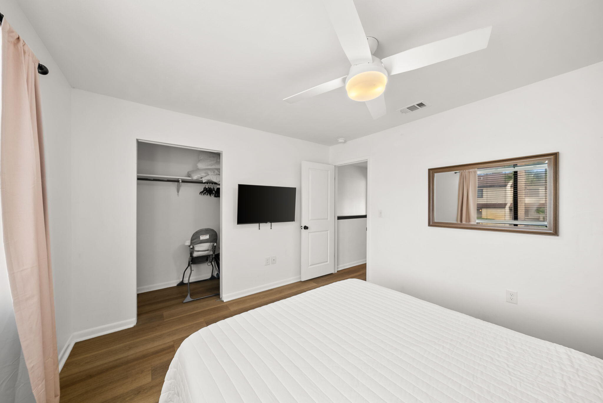 17620 Front Beach Road, Unit J2 Panama City Beach, FL 32413 - Photo 22 of 30 a bedroom with a bed and a flat screen tv