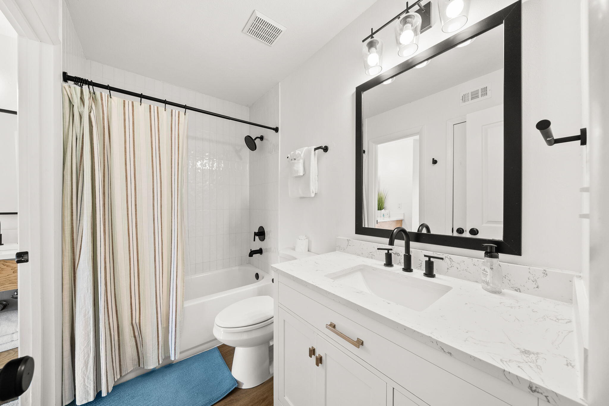 17620 Front Beach Road, Unit J2 Panama City Beach, FL 32413 - Photo 23 of 30 a bathroom with a double vanity sink mirror and toilet