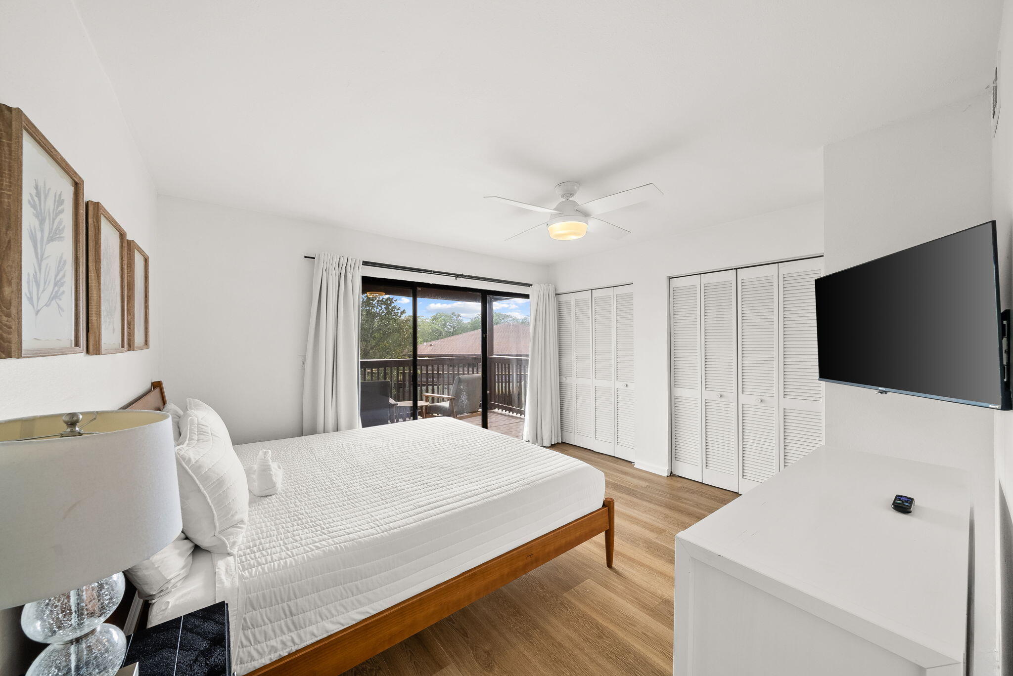 17620 Front Beach Road, Unit J2 Panama City Beach, FL 32413 - Photo 24 of 30 a bedroom with a bed and a flat screen tv