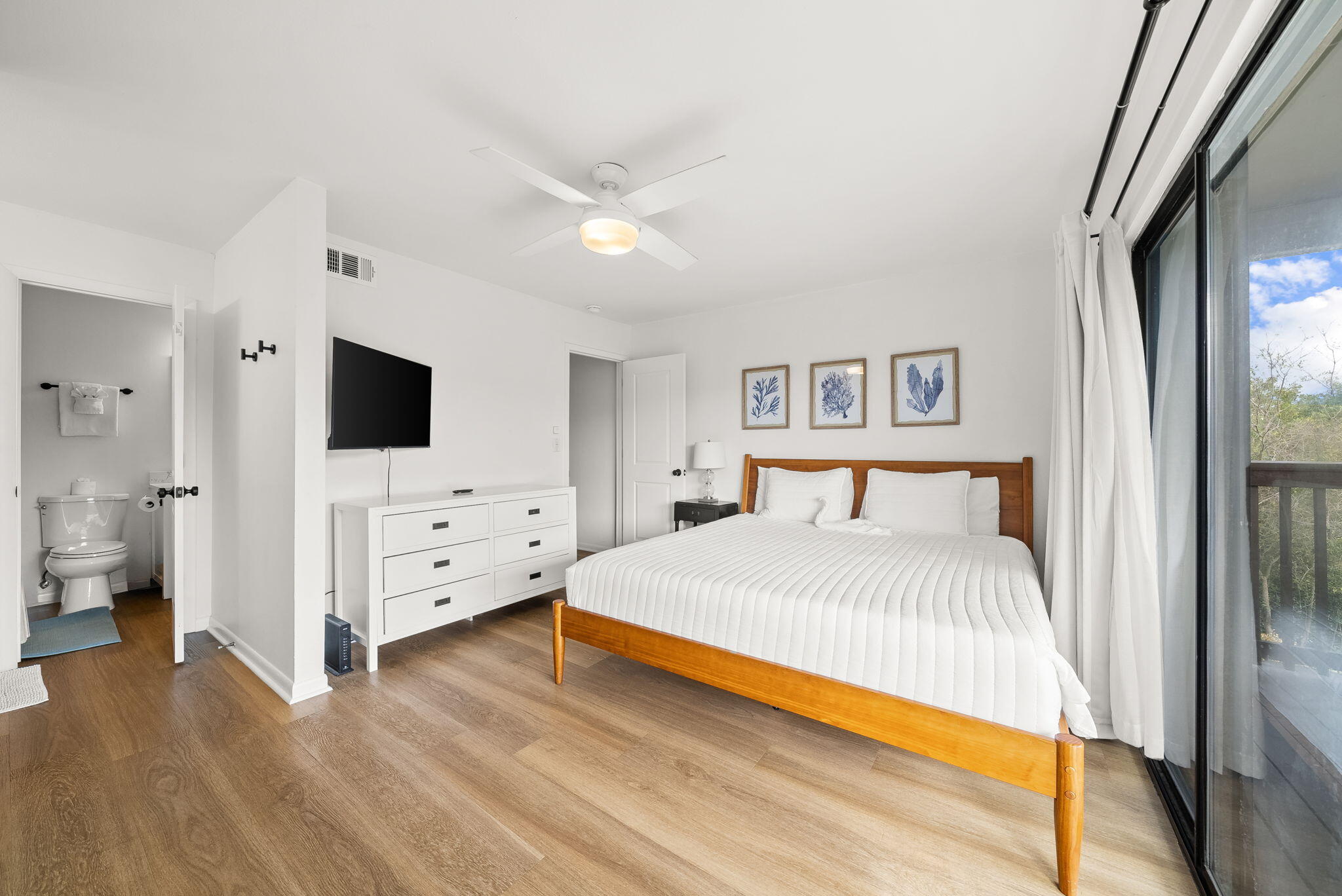 17620 Front Beach Road, Unit J2 Panama City Beach, FL 32413 - Photo 25 of 30 a bedroom with a bed and a flat tv screen on dresser