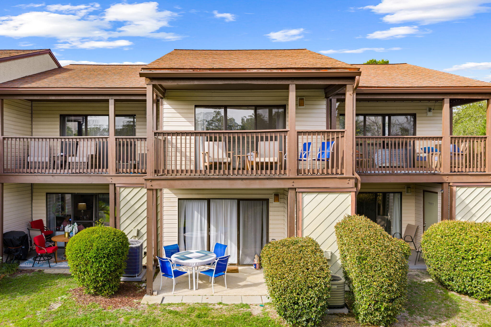 17620 Front Beach Road, Unit J2 Panama City Beach, FL 32413 - Photo 30 of 30 a view of a brick building with many windows and a large tree