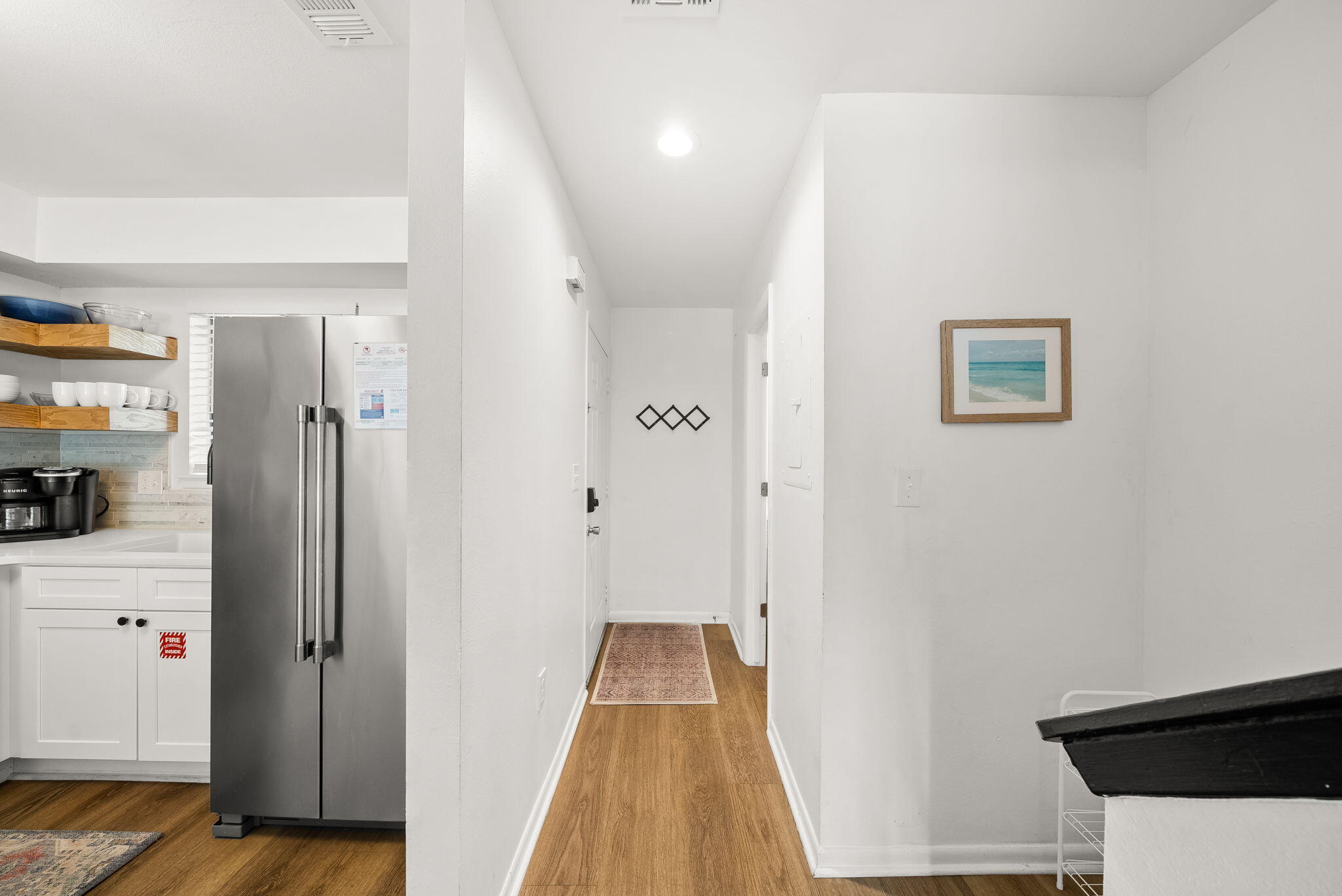 17620 Front Beach Road, Unit J2 Panama City Beach, FL 32413 - Photo 8 of 30 a view of a hallway with wooden floor and staircase