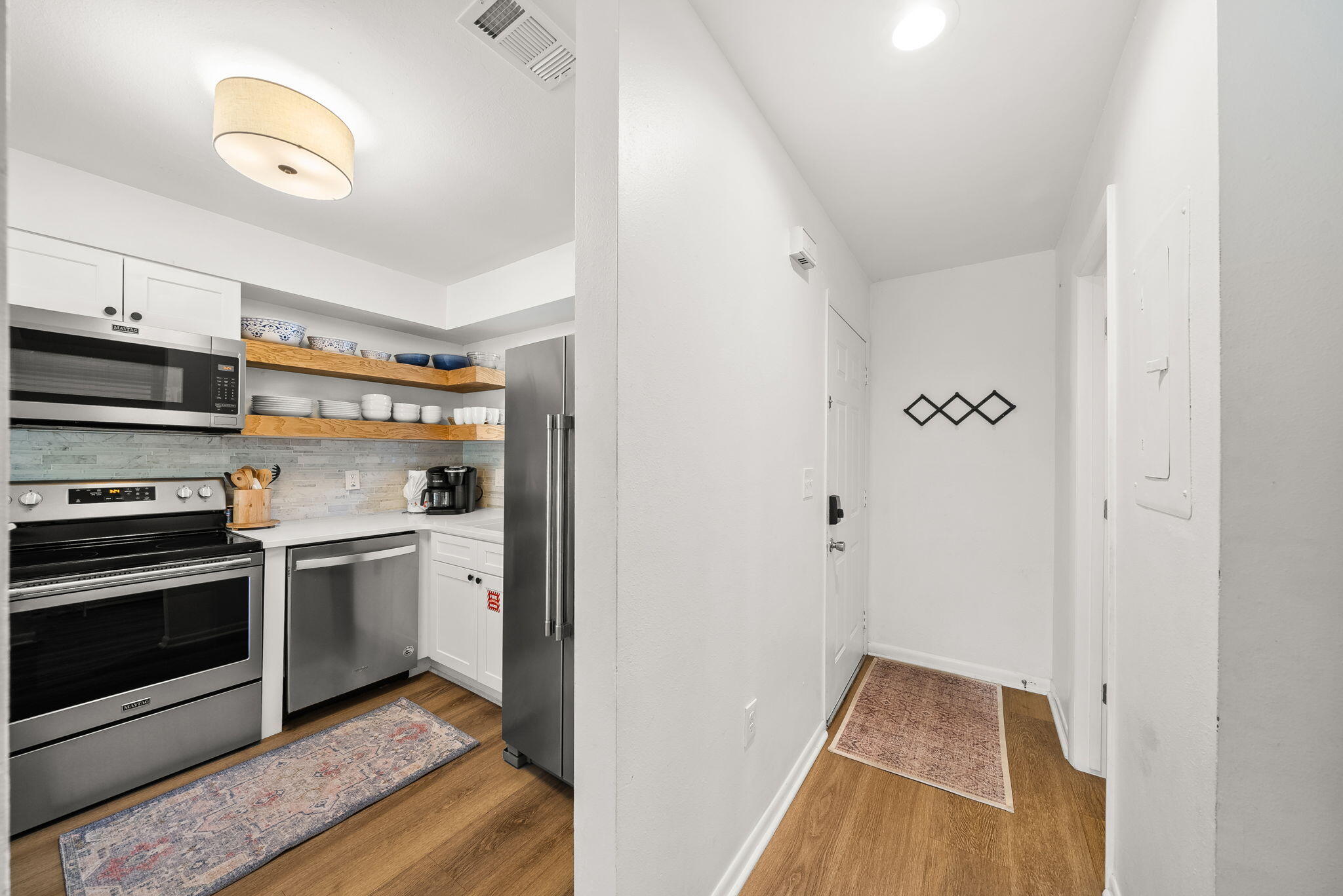 17620 Front Beach Road, Unit J2 Panama City Beach, FL 32413 - Photo 9 of 30 a kitchen with stainless steel appliances granite countertop a refrigerator and a stove top oven
