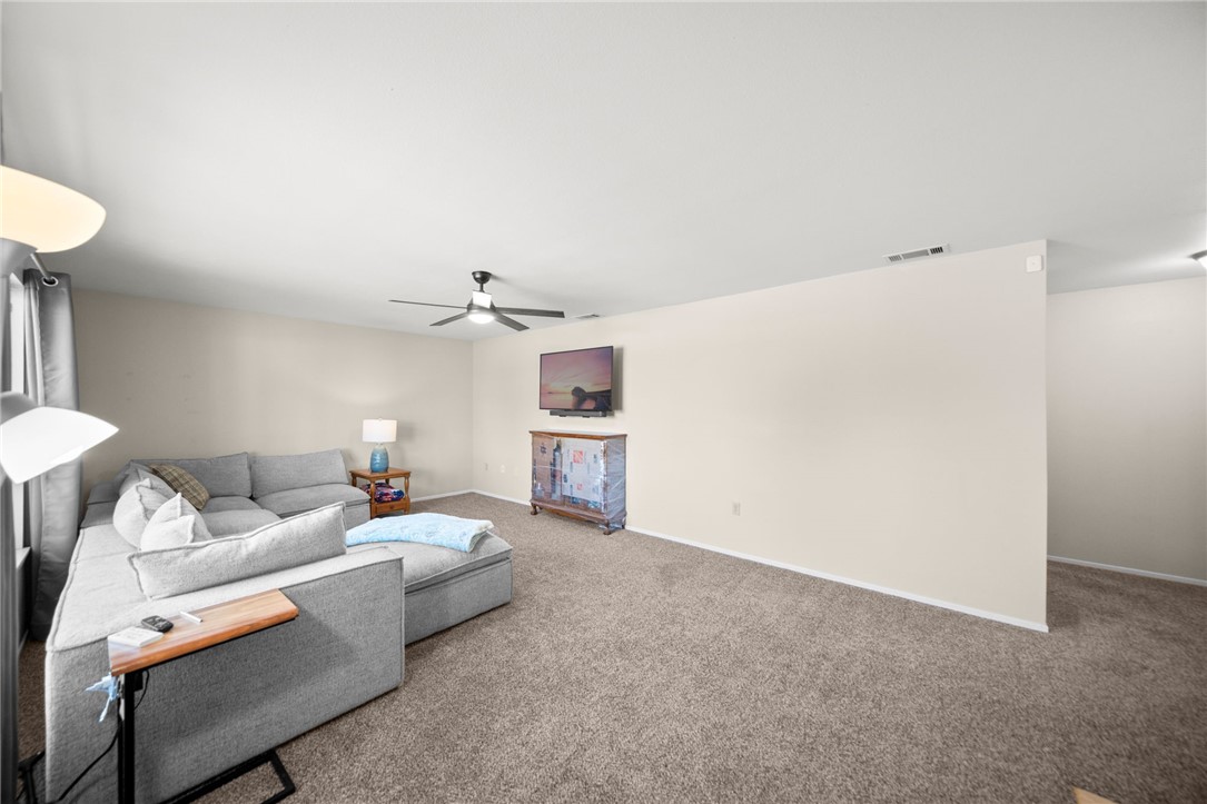 27879 Foxfire Street Menifee, CA 92586 - Photo 10 of 36 a living room with furniture and a lamp