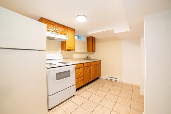 a kitchen with a stove a sink and a refrigerator