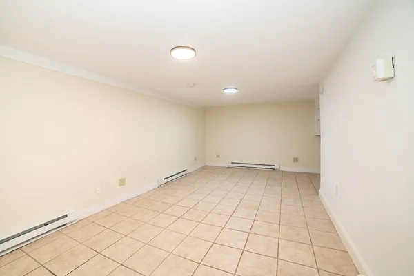 a view of a room with an empty space and a window