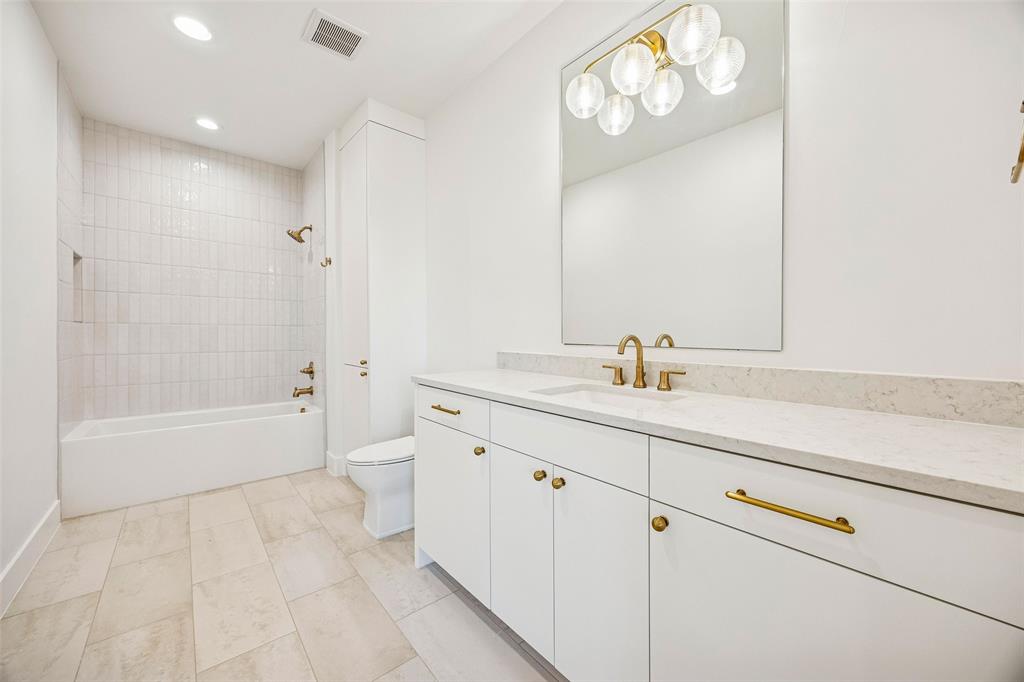 1410 Clydesdale Road Argyle, TX 76226 - Photo 29 of 40 a spacious bathroom with a granite countertop sink a toilet mirror and shower