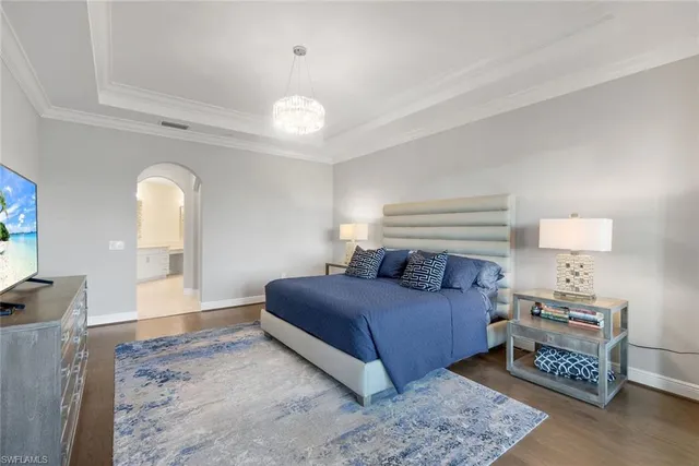 a living room with a bed furniture and a flat tv screen
