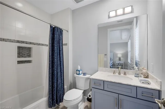 a bedroom with a bed and a lamp