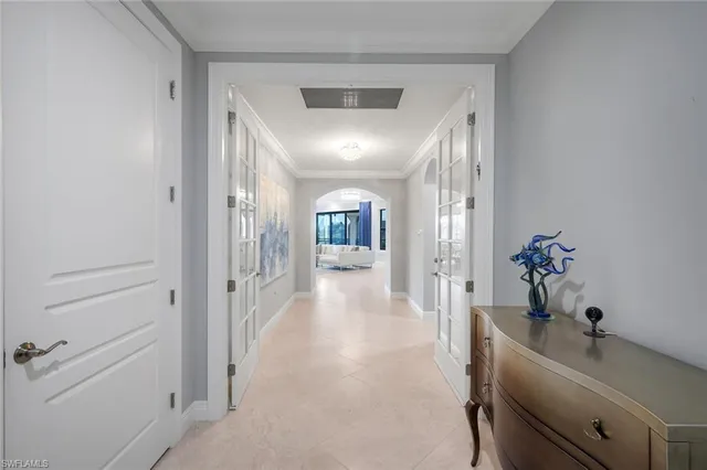 a hallway with a dining table and chairs