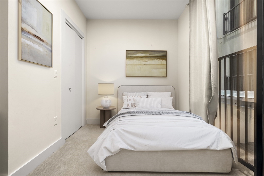 121-127 Portland Street, Unit 307 Boston, MA 02114 - Photo 12 of 27 a bedroom with a bed and a painting on the wall