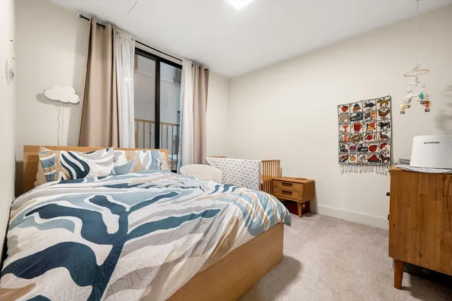 a bedroom with a bed and painting on the wall