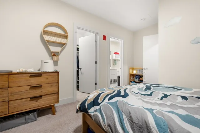 a bedroom with a bed and a mirror