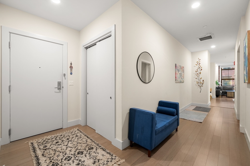 121-127 Portland Street, Unit 307 Boston, MA 02114 - Photo 17 of 27 a living room with furniture and a window